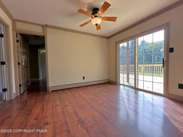 wooden floor in an empty room with a window