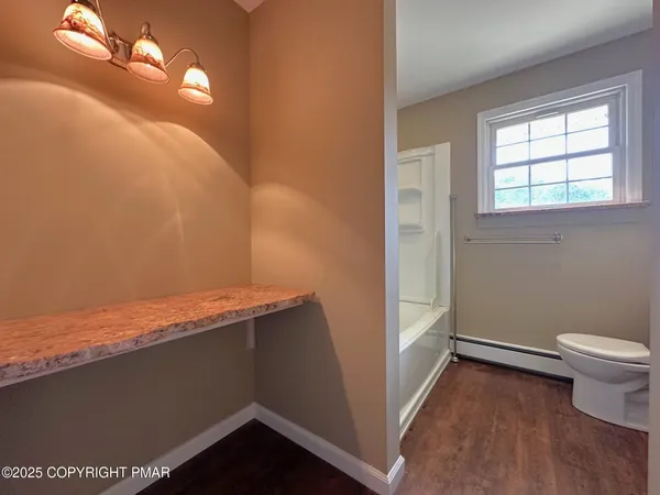 a view of a room with wooden floor
