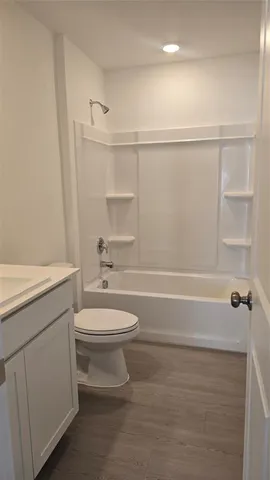 a bathroom with a toilet a sink and bathtub