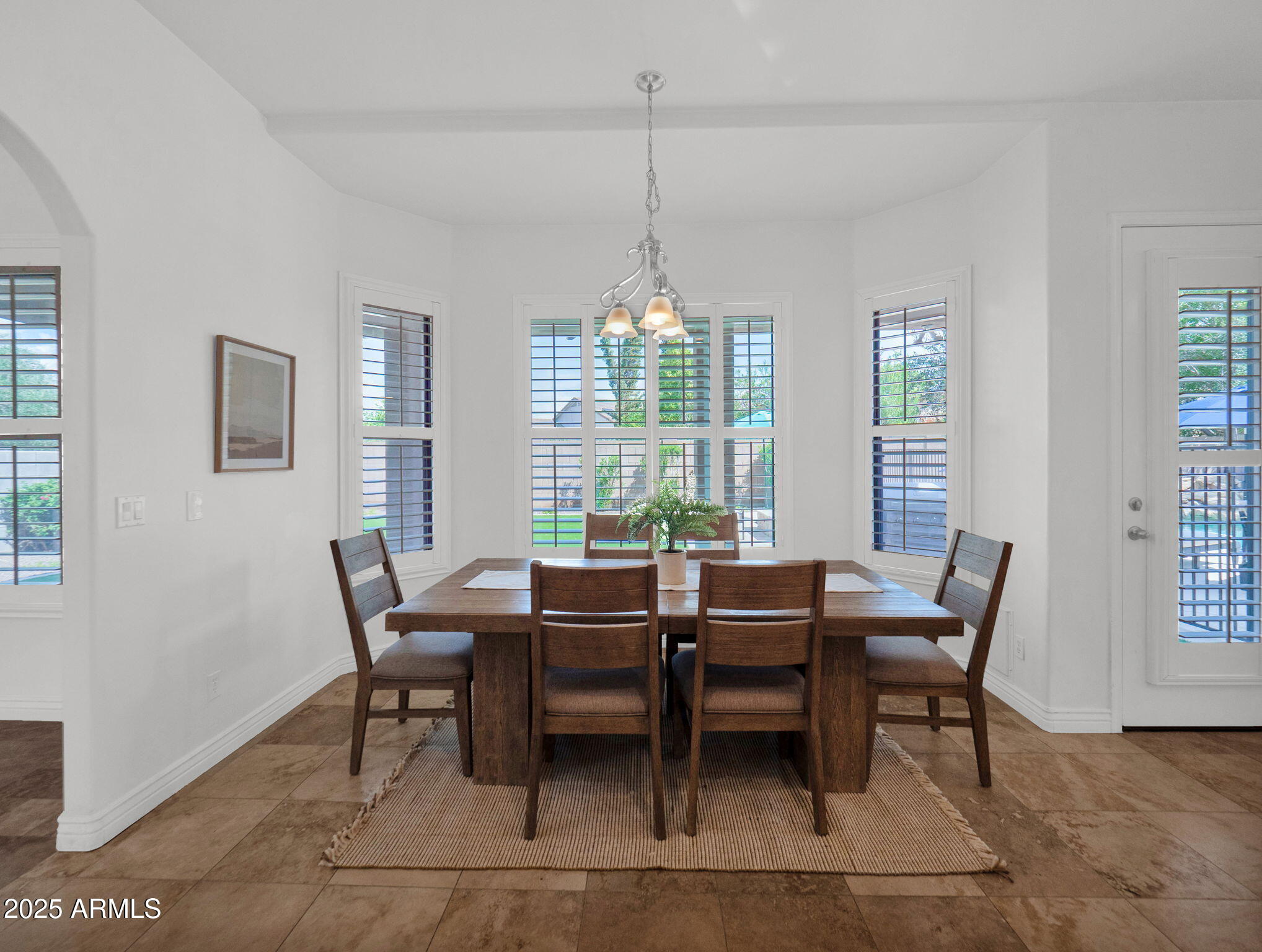28 East Joseph Way Gilbert, AZ 85295 - Photo 15 of 54 a dining room with furniture a chandelier and wooden floor