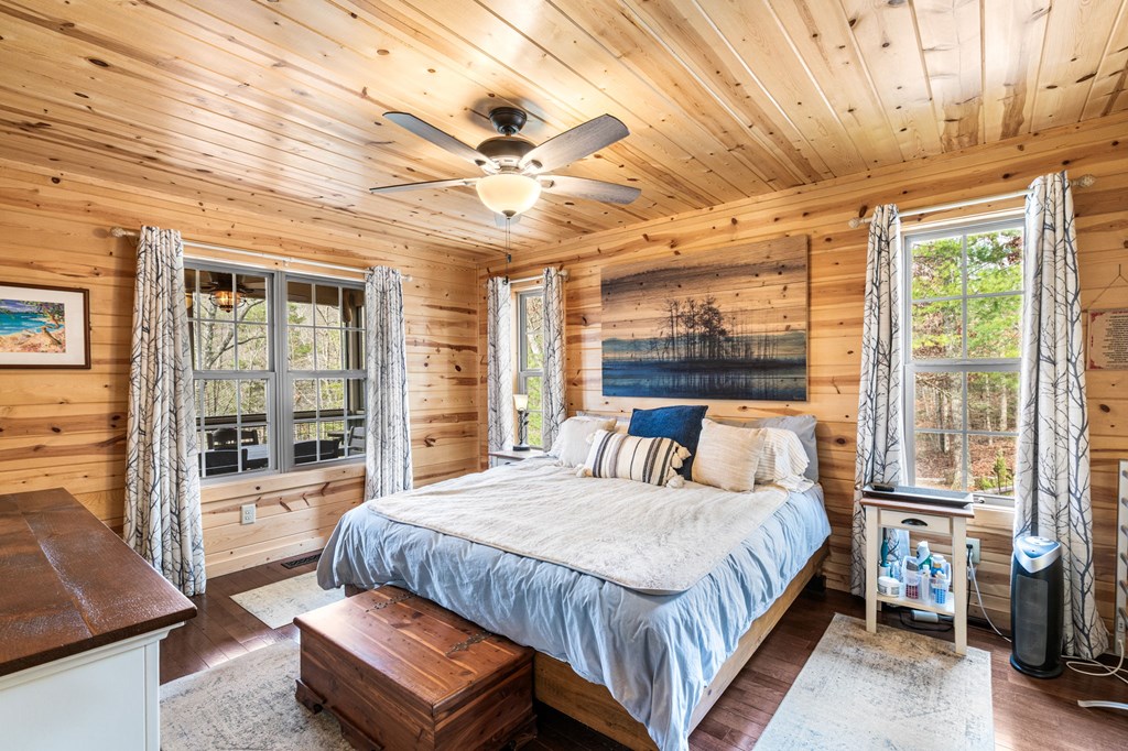 482 Tsalagi Trail Murphy, NC 28906 - Photo 12 of 44 a bedroom with a large bed and a chandelier