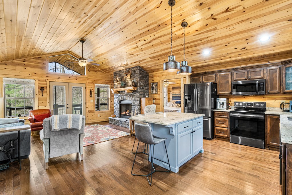 482 Tsalagi Trail Murphy, NC 28906 - Photo 6 of 44 a large kitchen with stainless steel appliances granite countertop a stove oven and a dining table with wooden floors