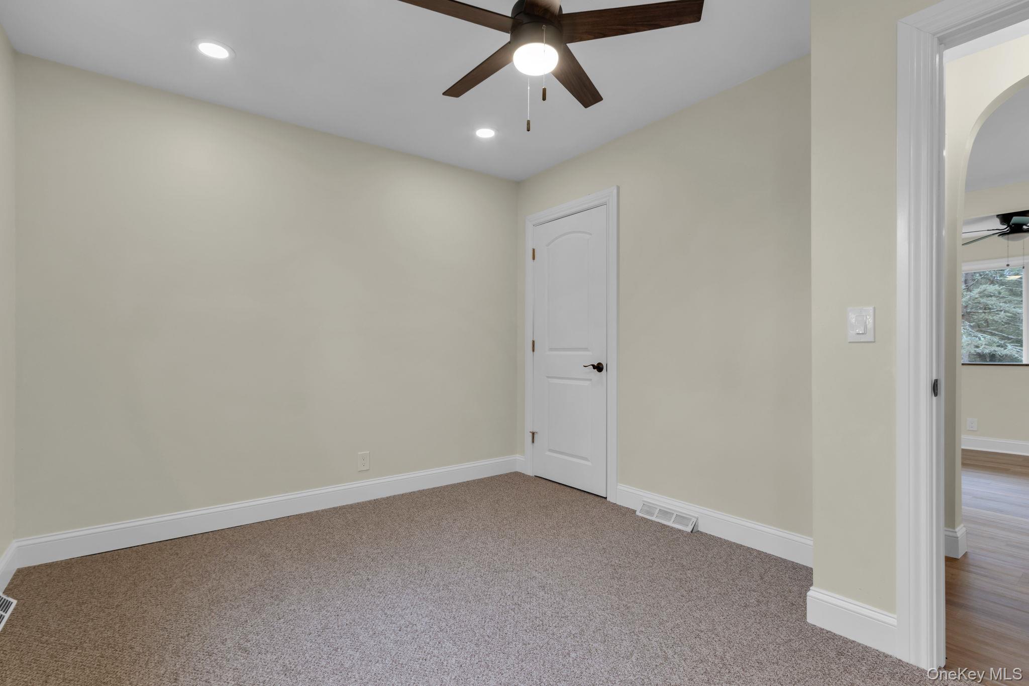21 Reading Road Patterson, NY 12563 - Photo 24 of 39 an empty room with a ceiling fan and carpet