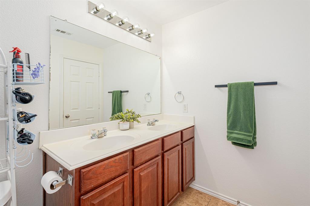 3521 Camino Real Trail Denton, TX 76208 - Photo 14 of 28 a bathroom with a sink and a mirror