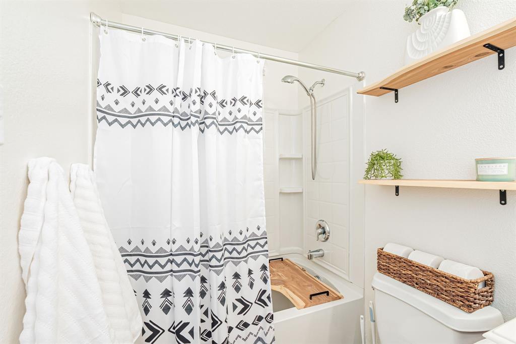 3521 Camino Real Trail Denton, TX 76208 - Photo 17 of 28 a bathroom with a shower curtain and a shower curtain