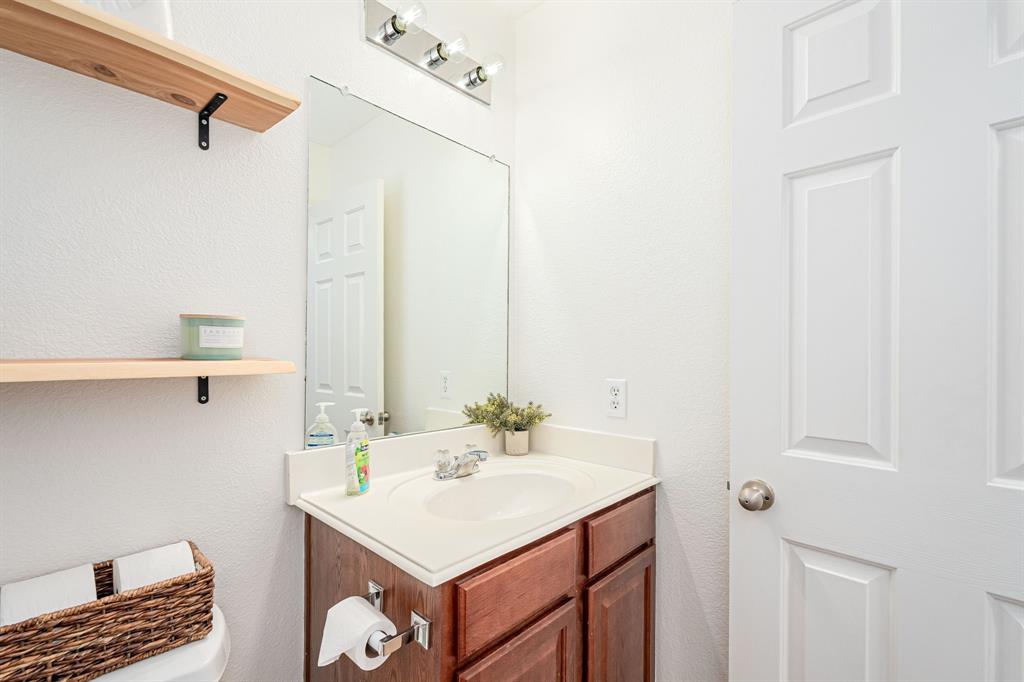 3521 Camino Real Trail Denton, TX 76208 - Photo 18 of 28 a bathroom with a sink vanity and a mirror