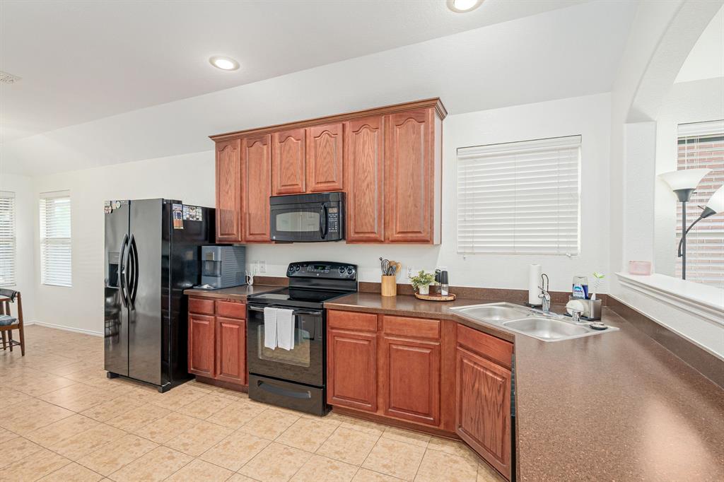 3521 Camino Real Trail Denton, TX 76208 - Photo 6 of 28 a kitchen with stainless steel appliances granite countertop a refrigerator stove top oven and sink