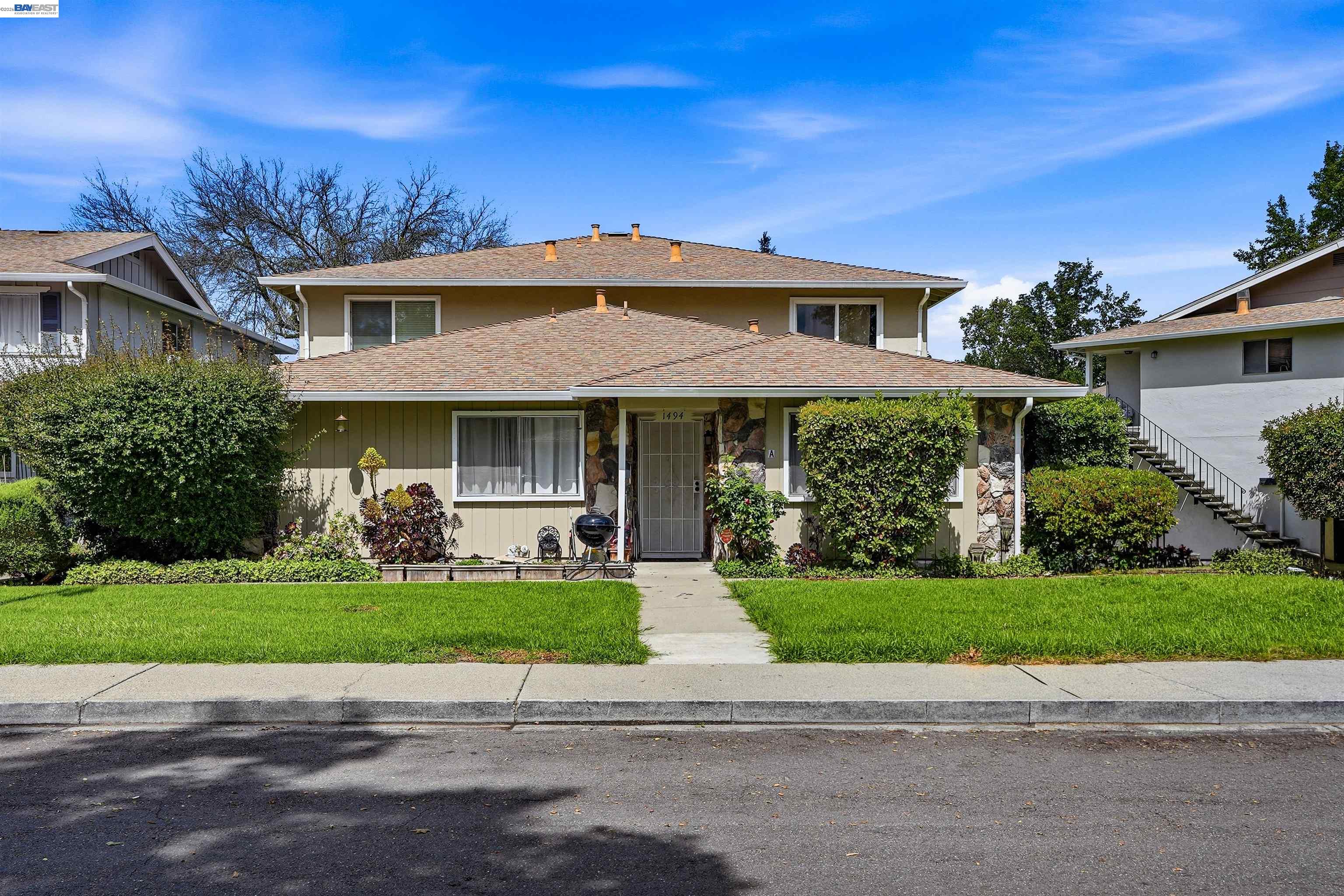 1494 Del Rio Circle, Unit D Concord, CA 94518 - Photo 1 of 8 a front view of a house with a yard