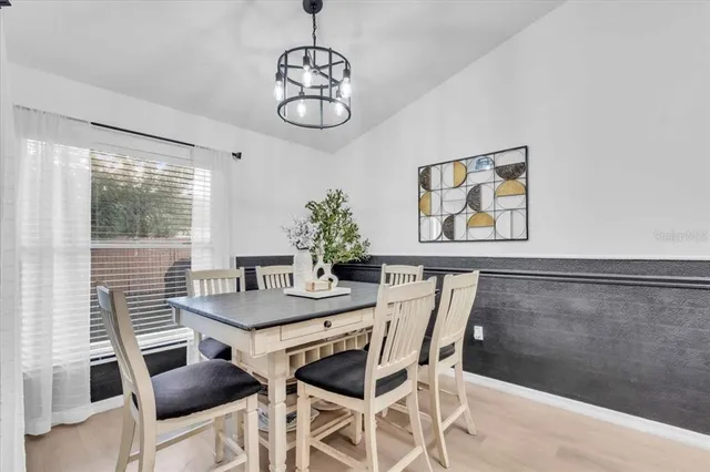 a view of a dining room with furniture large window and wooden floor