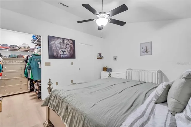 a bedroom with a bed and a chandelier