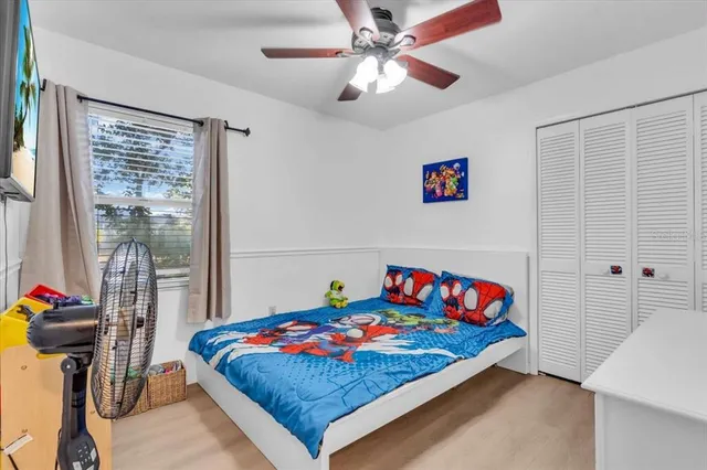 a bedroom with a bed and a chandelier