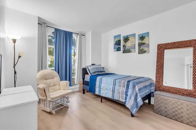 a bedroom with a bed and a chair