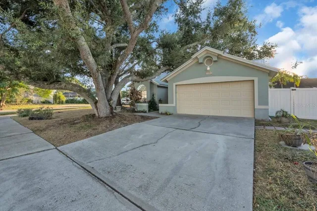 a view of a house with a yard and garage