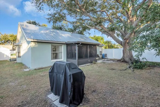 a view of a house with a yard and sitting area