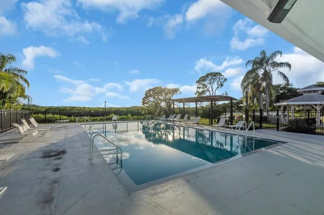 a view of a swimming pool with a lake from balcony