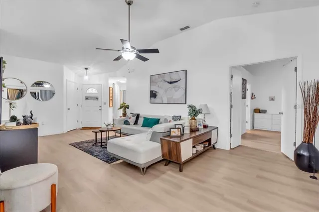 a spacious bedroom with a bed and a chandelier