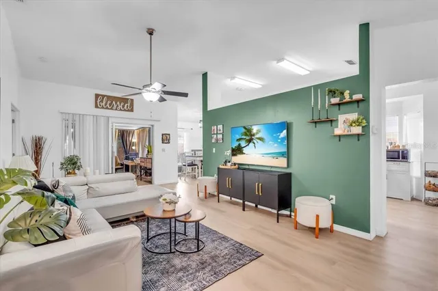 a living room with furniture a piano and a chandelier