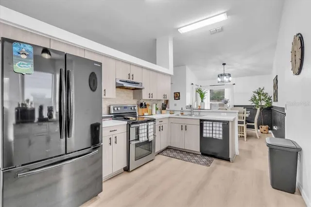 a kitchen with a refrigerator and a sink