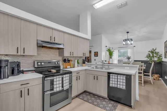 a kitchen with a sink stove and cabinets