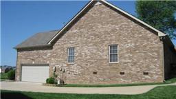 3555 Rabbit Run Trail Clarksville, TN 37043 - Photo 17 of 19 A Side View of the All Brick Ranch Home Features Bonus Room and New Garage Doors & Openers.