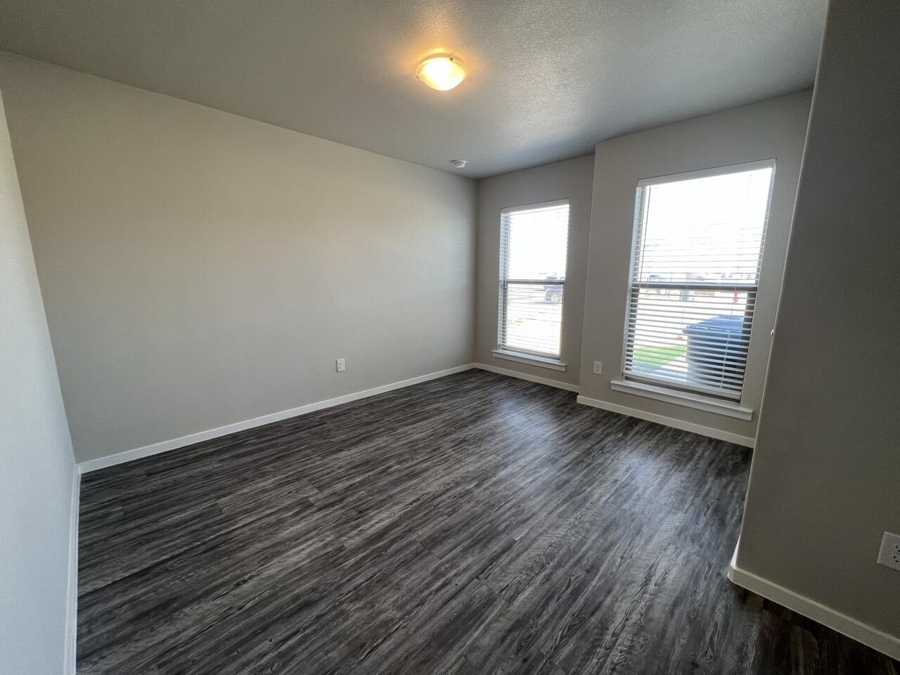 2139 North Texas Avenue, Unit A Lubbock, TX 79403 - Photo 18 of 21 wooden floor in an empty room with a window