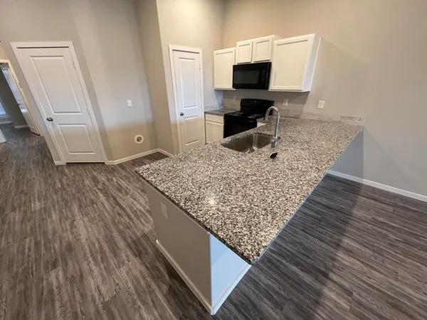 a living room with chair and a flat screen tv