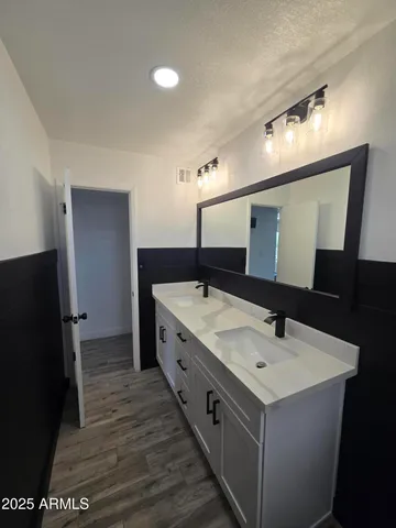 a bathroom with a double vanity sink and mirror