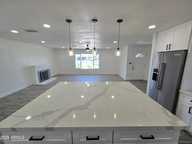 a view of a kitchen with a sink and refrigerator