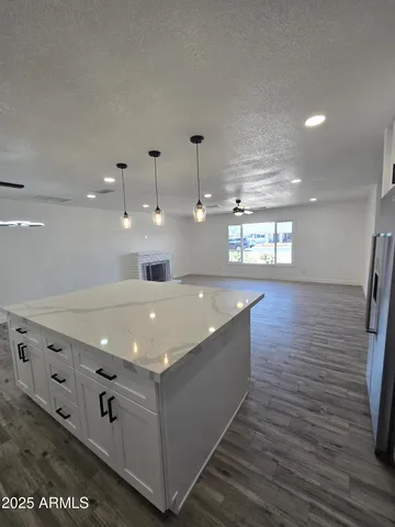 a large kitchen with stainless steel appliances granite countertop a lot of counter space