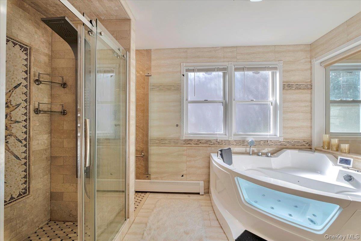 193 Nelson Road Scarsdale, NY 10583 - Photo 24 of 37 a bathroom with a tub sink and mirror