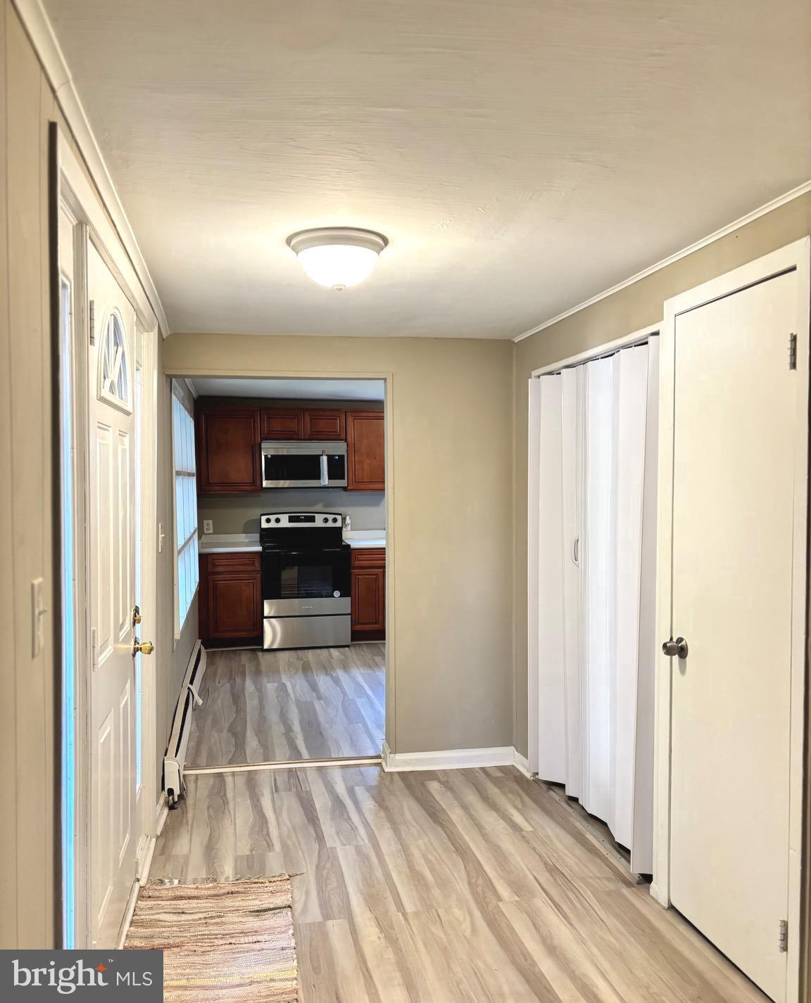 518 Columbus Road Burlington, NJ 08016 - Photo 7 of 26 a view of a hallway with wooden floor and a living room