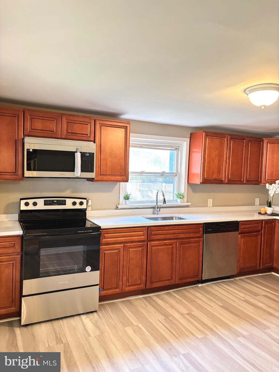 518 Columbus Road Burlington, NJ 08016 - Photo 9 of 26 a kitchen with stainless steel appliances granite countertop a stove a sink and a microwave