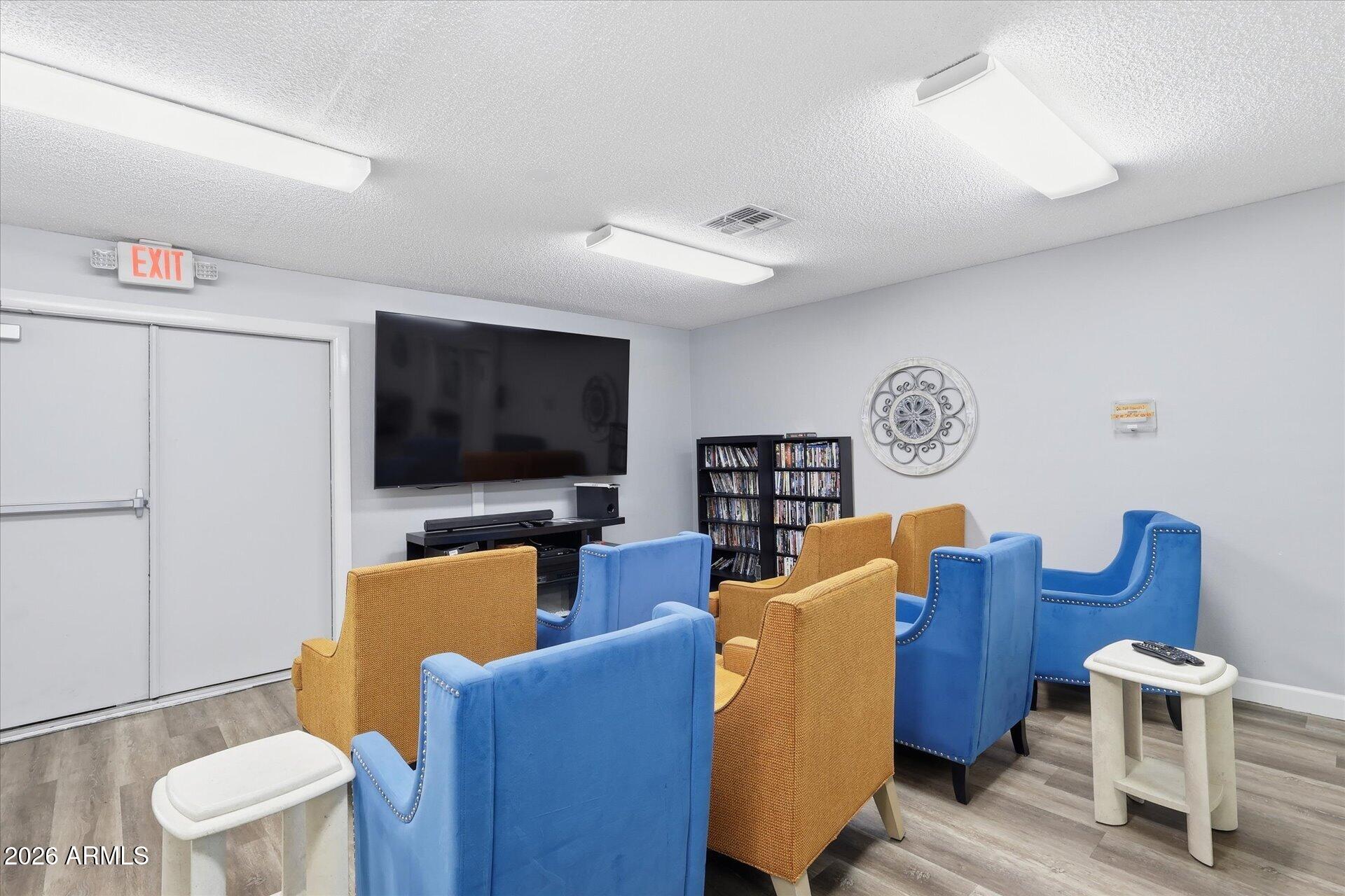 3270 South Goldfield Road, Unit 716 Apache Junction, AZ 85119 - Photo 25 of 36 a living room with furniture and a flat screen tv