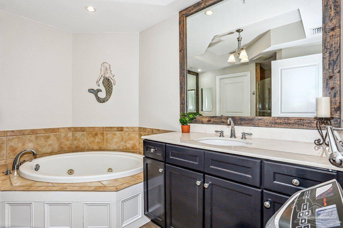 608 Lost Key Drive, Unit 201C Perdido Key, FL 32507 - Photo 19 of 42 a bathroom with a tub a sink and mirror