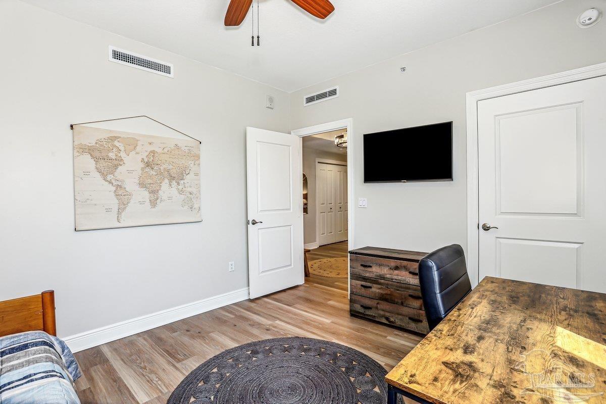 608 Lost Key Drive, Unit 201C Perdido Key, FL 32507 - Photo 23 of 42 a bedroom with a bed and flat screen tv
