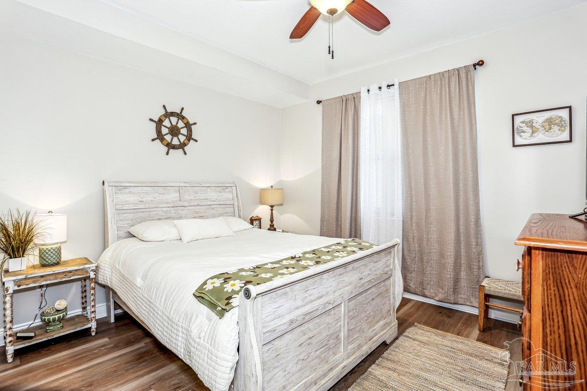 608 Lost Key Drive, Unit 201C Perdido Key, FL 32507 - Photo 24 of 42 a bedroom with a large bed and a chandelier