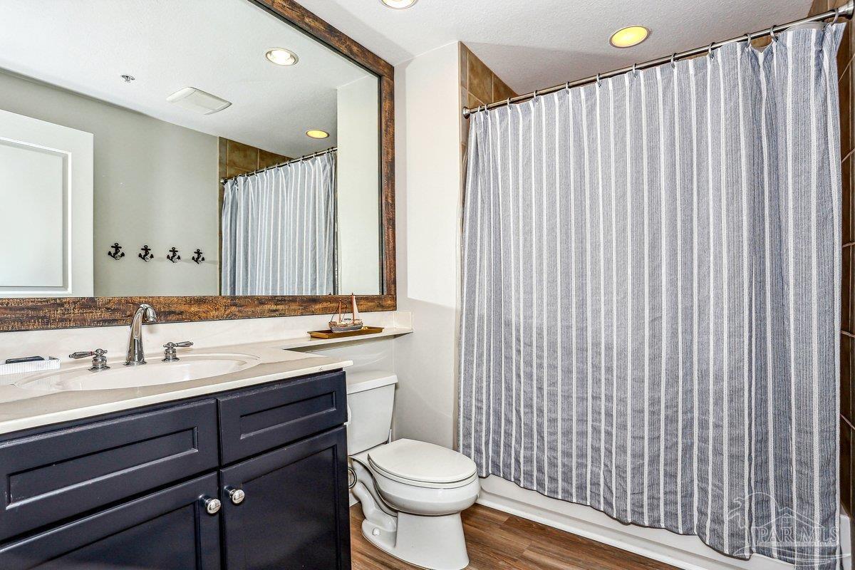 608 Lost Key Drive, Unit 201C Perdido Key, FL 32507 - Photo 26 of 42 a bathroom with a toilet sink and mirror