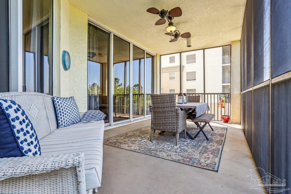 608 Lost Key Drive, Unit 201C Perdido Key, FL 32507 - Photo 31 of 42 a living room with furniture windows and a table