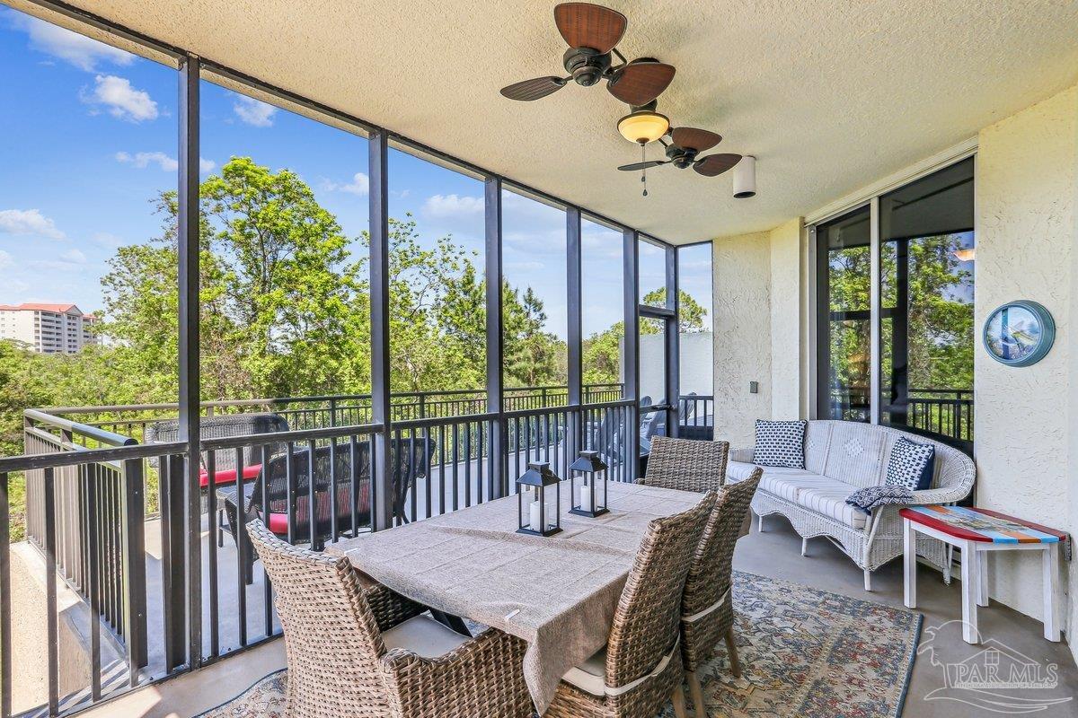 608 Lost Key Drive, Unit 201C Perdido Key, FL 32507 - Photo 32 of 42 a view of a patio with a dining table and chairs