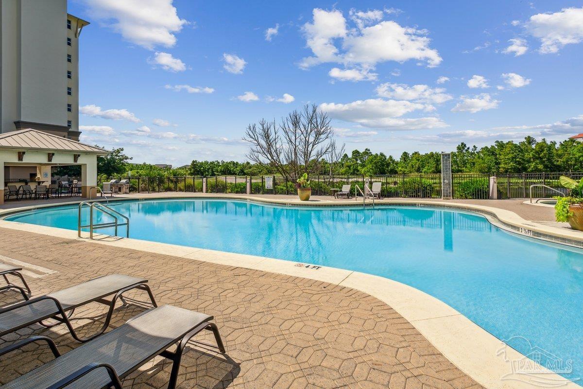 608 Lost Key Drive, Unit 201C Perdido Key, FL 32507 - Photo 33 of 42 a view of a swimming pool with an outdoor seating and a yard