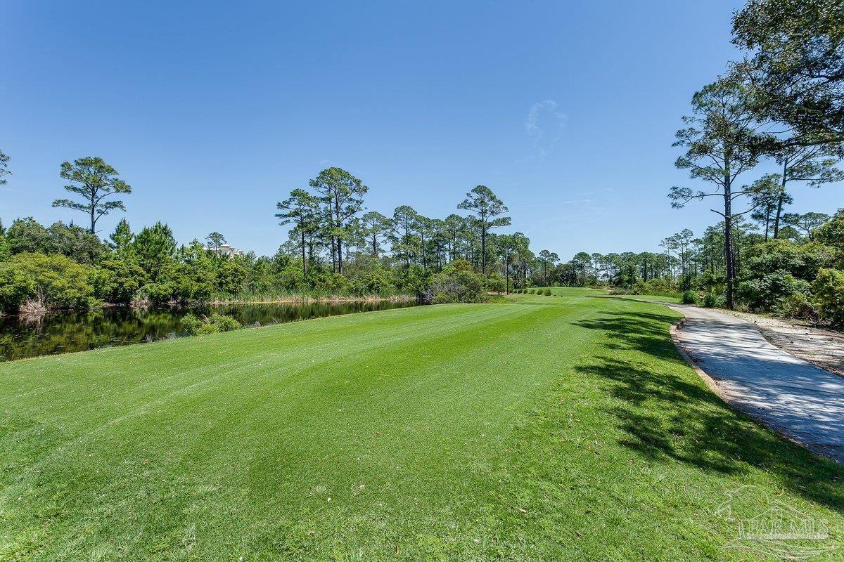 608 Lost Key Drive, Unit 201C Perdido Key, FL 32507 - Photo 37 of 42 a view of a grassy field with trees