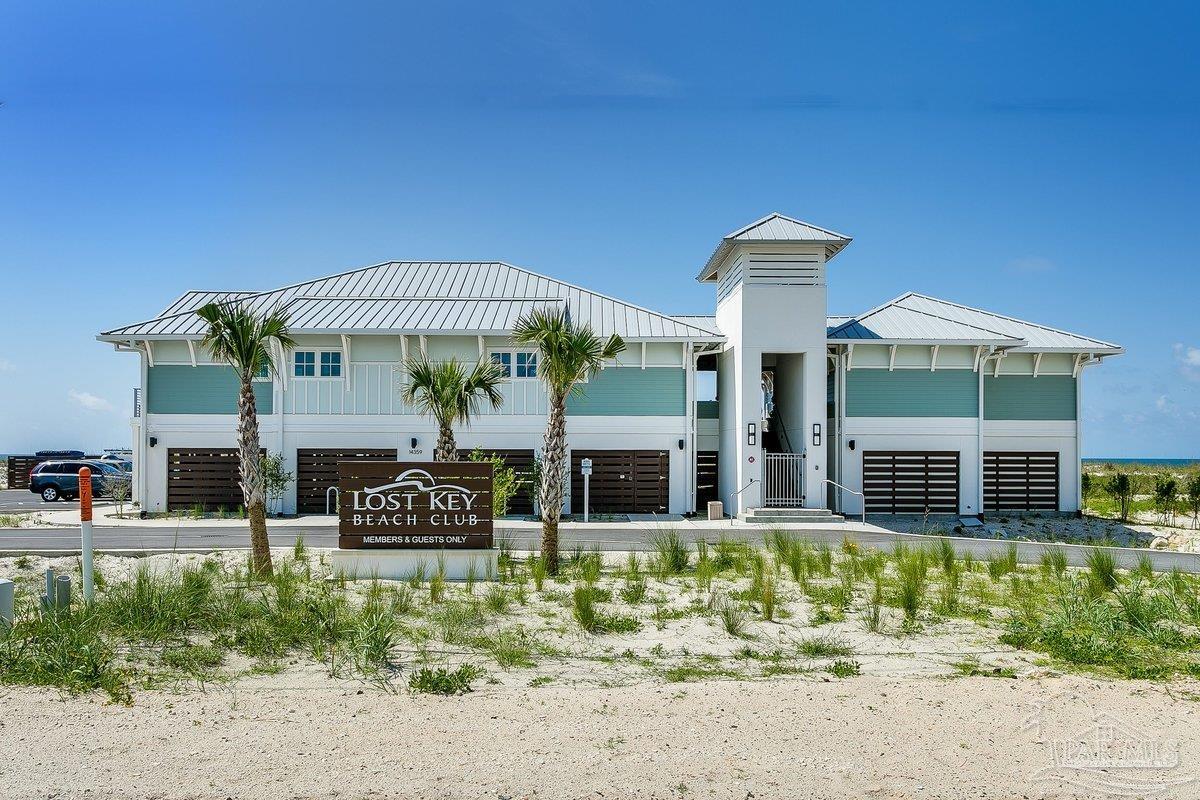 608 Lost Key Drive, Unit 201C Perdido Key, FL 32507 - Photo 38 of 42 a front view of a house with garden