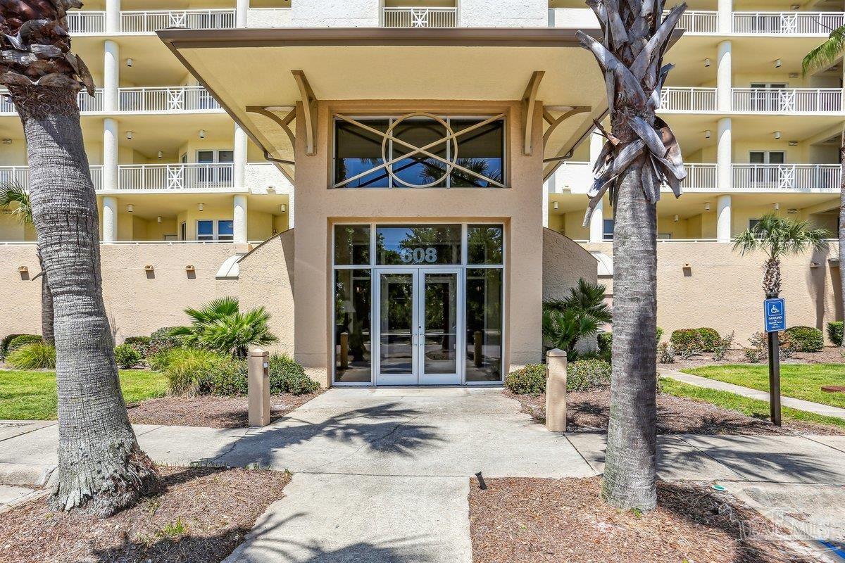 608 Lost Key Drive, Unit 201C Perdido Key, FL 32507 - Photo 4 of 42 a front view of a building with garden
