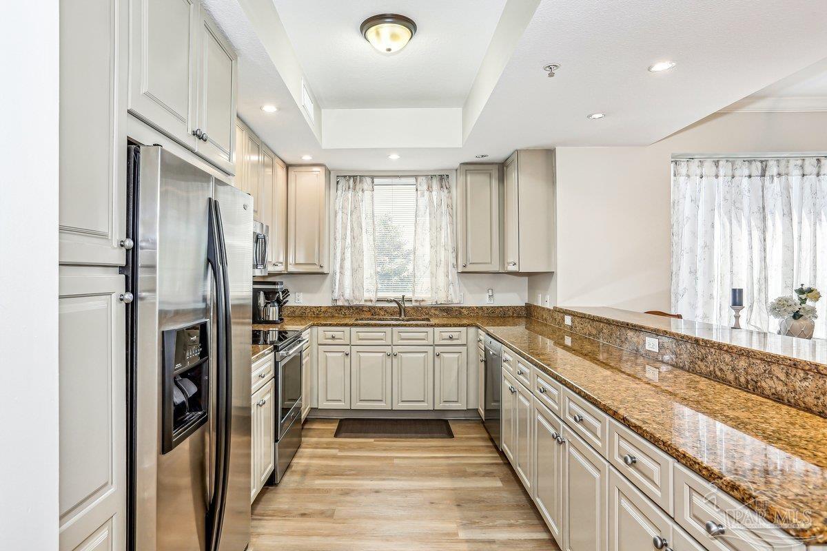 608 Lost Key Drive, Unit 201C Perdido Key, FL 32507 - Photo 8 of 42 a kitchen with stainless steel appliances granite countertop a refrigerator and a sink
