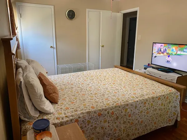 a bedroom with a bed and a mirror