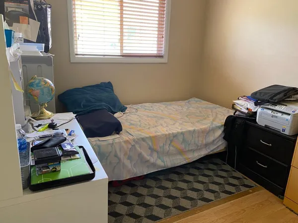 a bedroom with a bed and a window