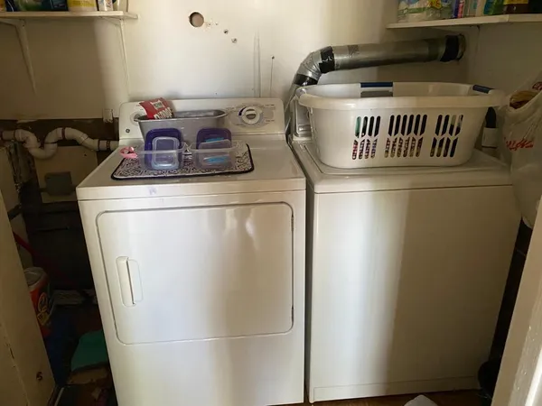 a close up of a utility room with washer and dryer