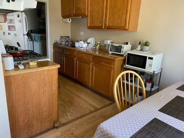 a kitchen with stainless steel appliances granite countertop a stove a sink dishwasher and cabinets with wooden floor