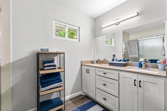 a hallway with cabinets and wooden floor