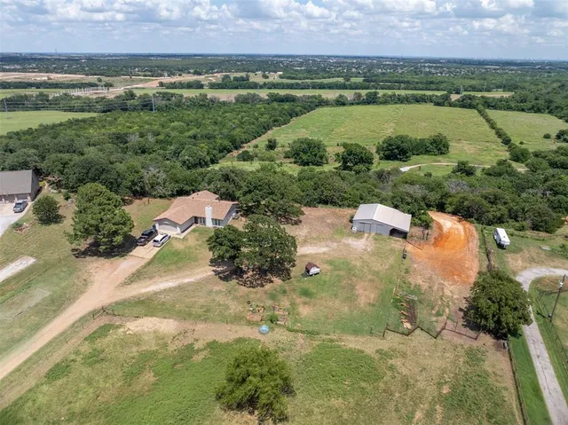 an aerial view of a houses with outdoor space and lake view